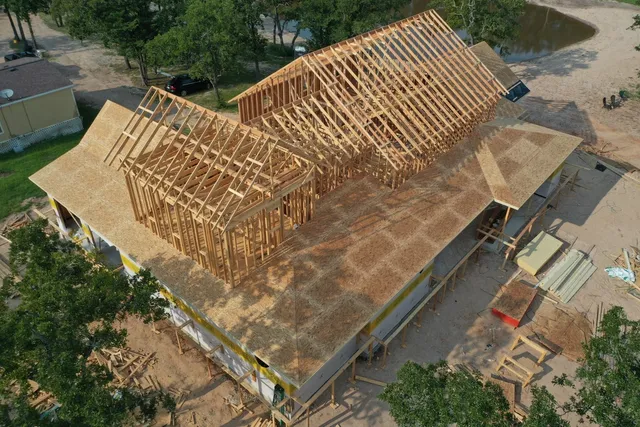 Birdseye view of the wooden frame of a custom built home.
