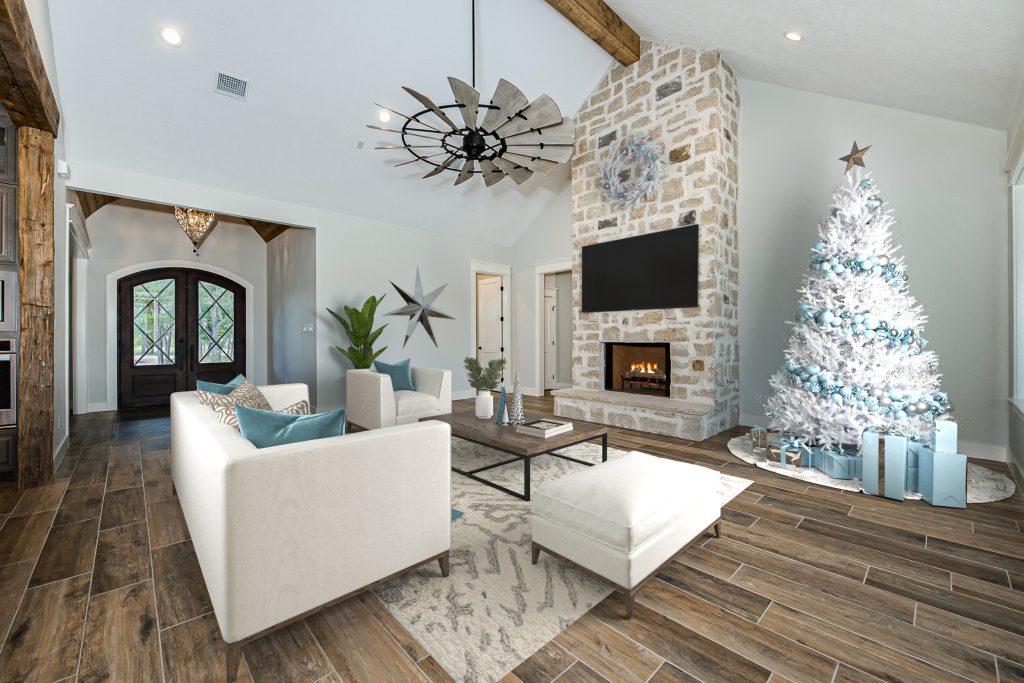 A living room decorated for Christmas with a white Christmas tree and blue ornaments.